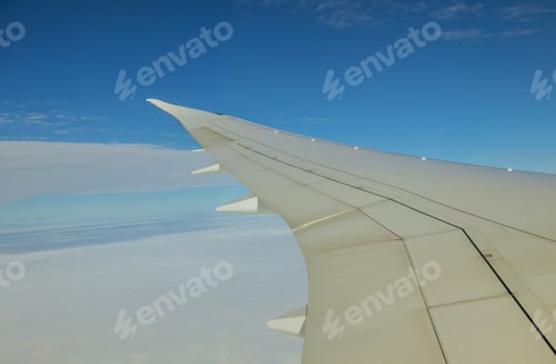 Preview: Clouds and sky as seen on a wing of an airplane flying