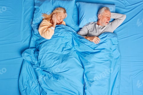 Preview: Senior woman cannot stand husband snore covers ears has insomnia. Mature married family couple have