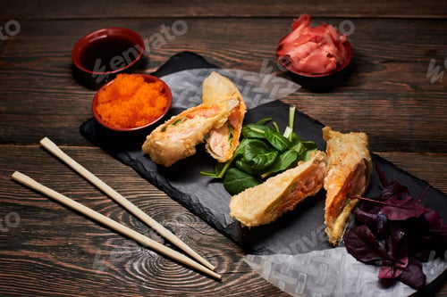 Preview: Japanese tempura dish with green, red basil, rice paper on stone plate.