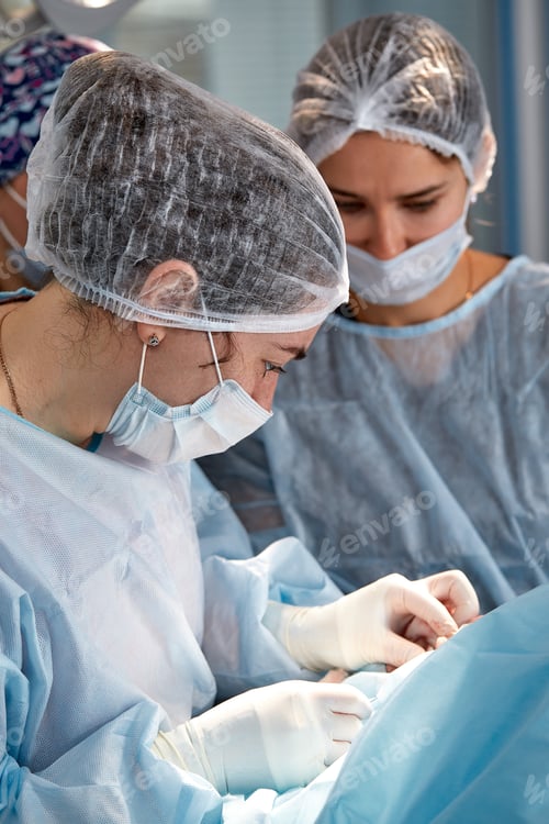 Preview: Concentrated Surgical team operating a patient in an operation theater