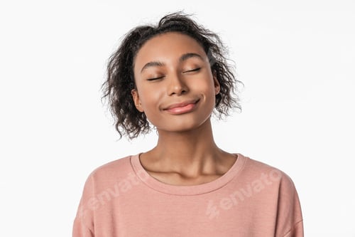 Preview: Portrait of cute young woman with closed eyes dreaming while standing over white background