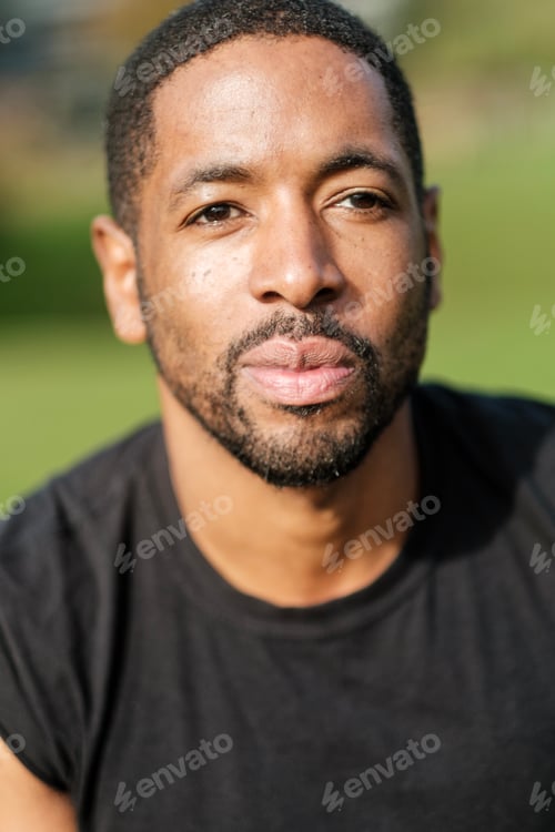 Preview: Portrait of confident african american man wearing black t-shirt outdoors