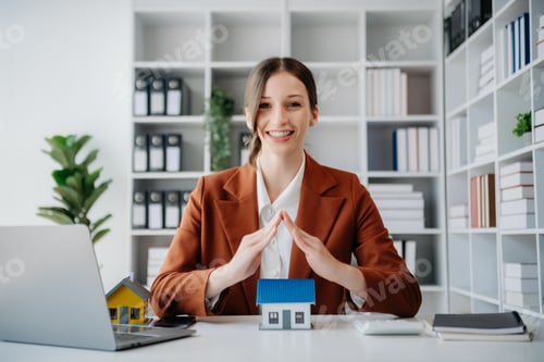 Preview: Female real estate agent is use hands to protect red roof for the concept of real estate