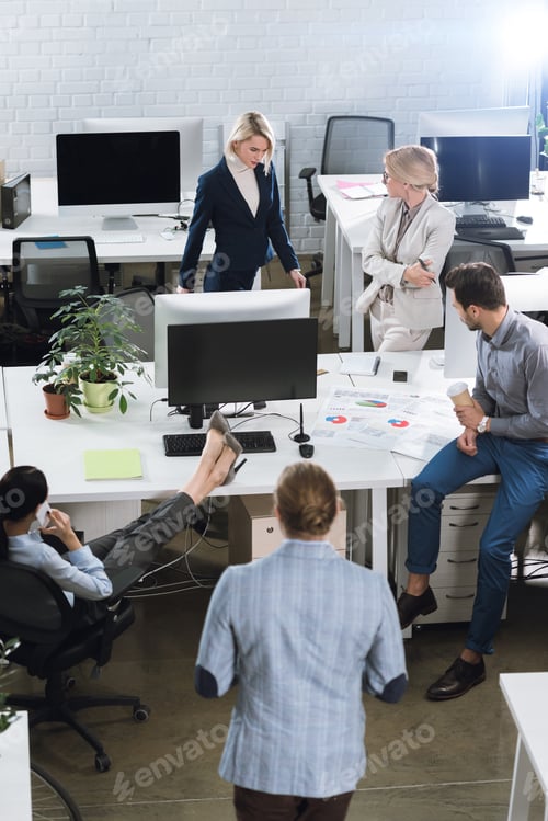 Preview: high angle view of business colleagues working in office