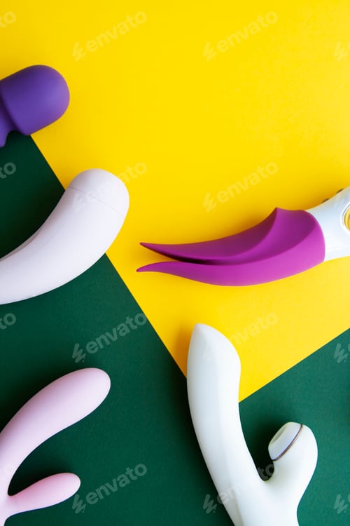 Preview: Collection of different types of sex toys on a green and yellow background.