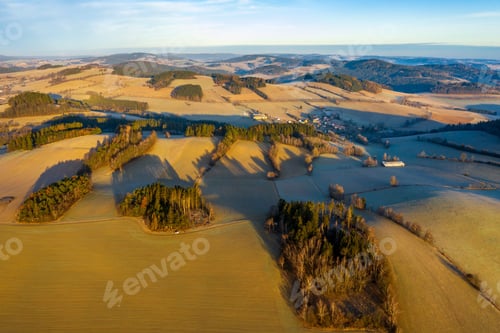 Preview: High angle shot of a beautiful landscape with tree ranges under the cloudy sky