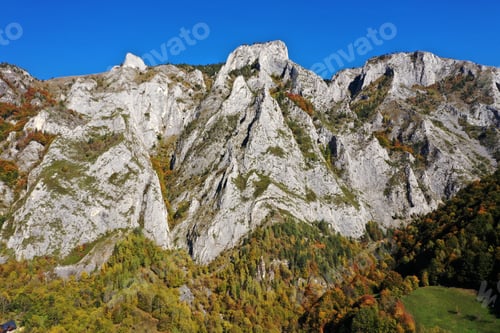 Preview: Aerial view of rocky limestone mountains and autumn forest