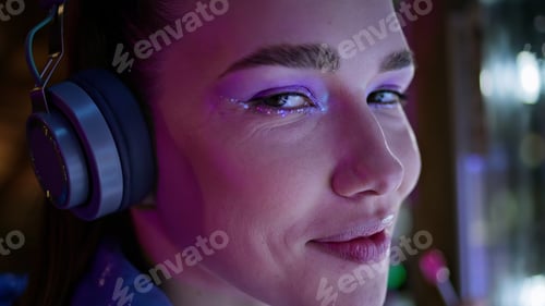 Preview: Woman modern bright makeup looking camera closeup. Portrait girl in headphones.