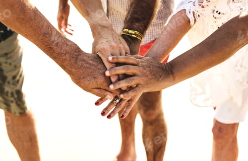 Preview: Group of senior friends stacking hands