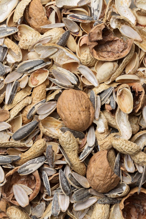 Preview: Pile of mixed nuts shells as background. Texture