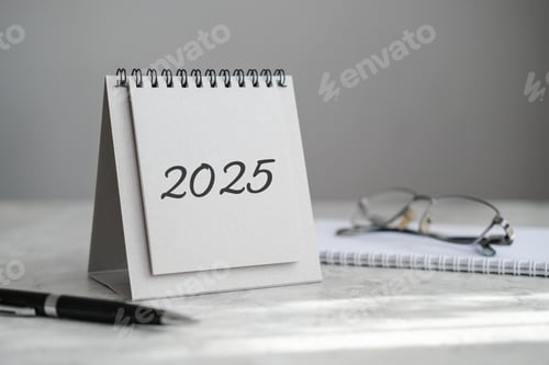 Preview: Desk calendar 2025, notebook, glasses and pen on the table