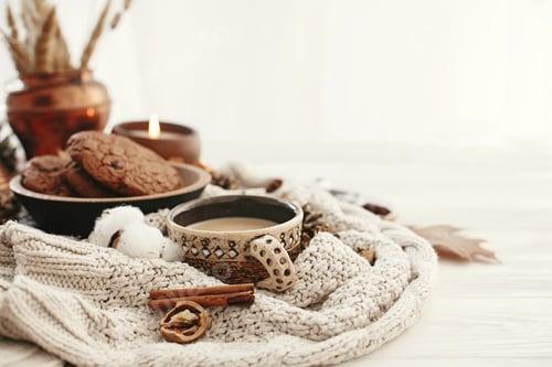 Preview: Hygge lifestyle, cozy autumn mood. Coffee cup, chocolate cookies, candle and fall leaves