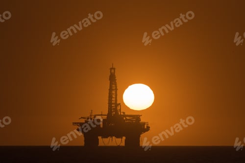 Preview: Sun setting over oil drilling platform at Longbeach in Namibia