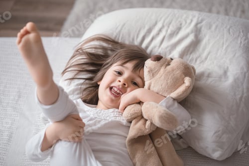 Preview: Little cute girl in bed with toy