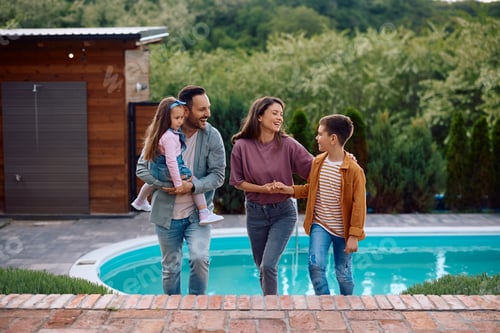 Preview: Cheerful parents and their kids enjoying in family day outdoors.