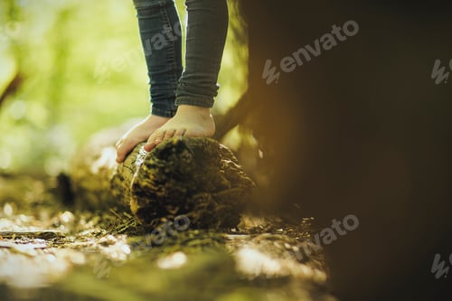 Preview: Girl in forest standing on log