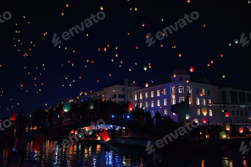 Preview: Beautiful view of sky lanterns floating in the night in Volos, Greece, creating the Christmas spirit