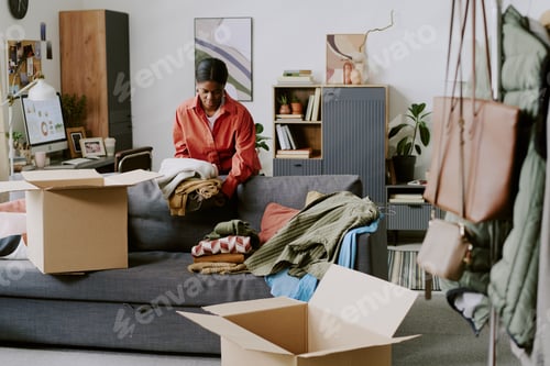 Preview: Black Woman Packing Clothing Orders for Online Resale Business