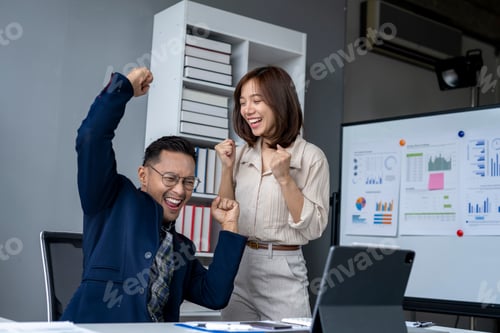Preview: A man and a woman are celebrating in a business setting