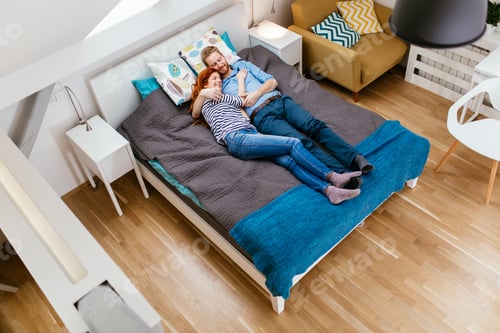 Preview: Beautiful couple resting on bed