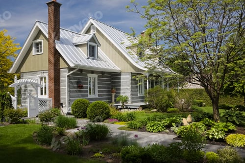 Preview: Stacked log home with Amur Maackia tree in front yard at springtime, Quebec, Canada