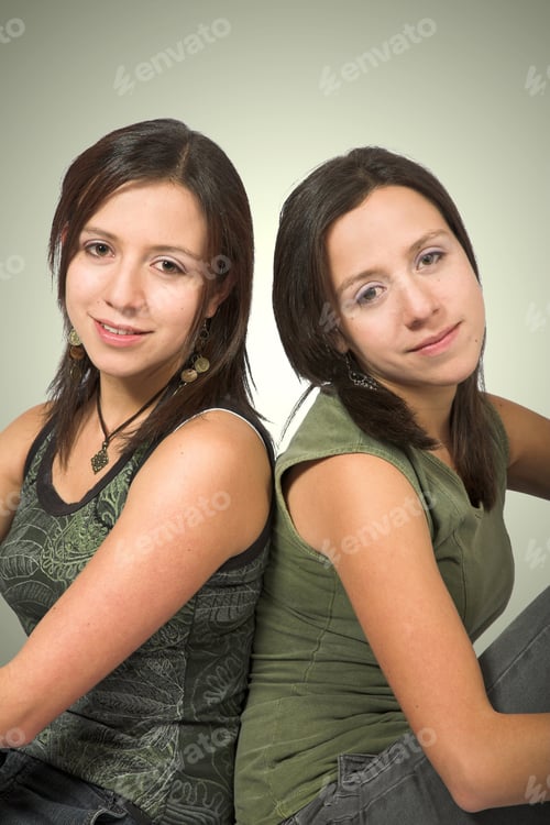 Preview: Beautiful Twin Sisters In Green Over A Green Background