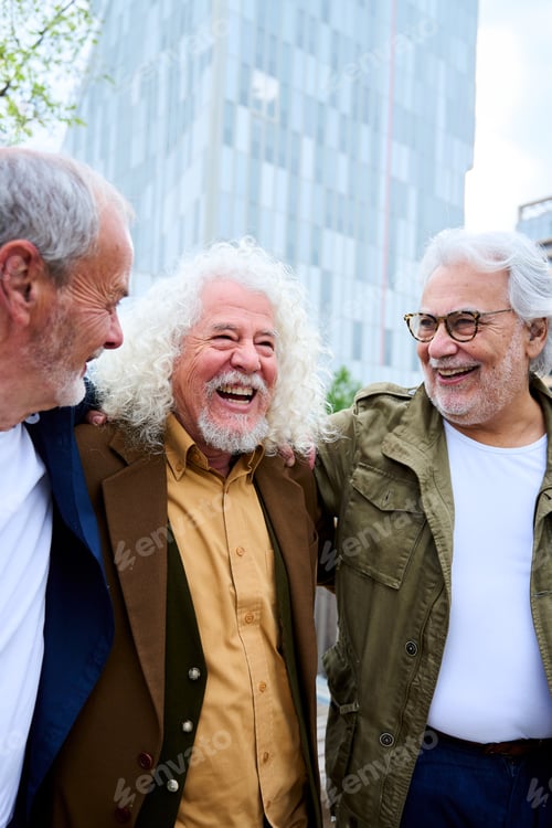 Vista previa: Group of three mature caucasian men enjoying embracing walk together laughing outdoor