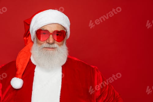 Preview: Portrait funny Santa Claus wearing sunglasses looking at camera isolated red background copy space