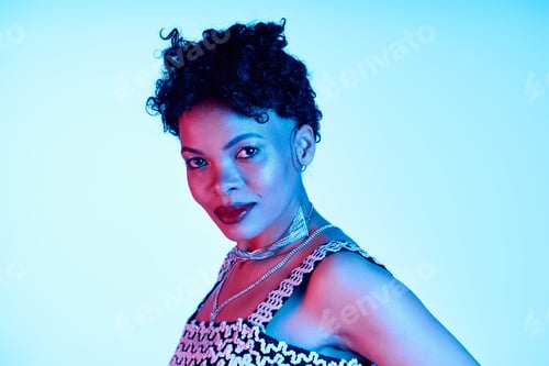 Preview: Stylish African American woman confidently posing with modern flair in vibrant lighting