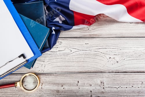 Preview: blank clip board and USA flag on wooden background