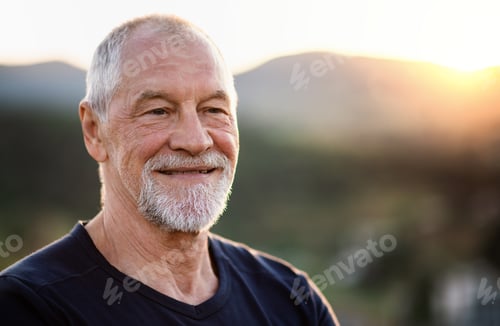 Preview: Portrait of senior tourist hiker standing in nature. Copy space