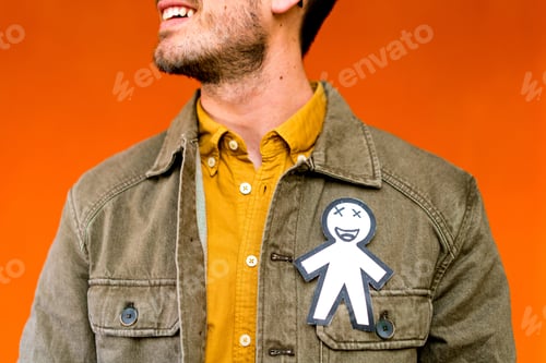 Preview: Smiling man with funny paper toy on jean jacket