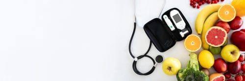 Preview: Glucometer and stethoscope on white table with medical tech, organic vegetables and fruits, copy