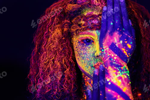 Preview: Cropped portrait of a young woman posing with neon paint on her face