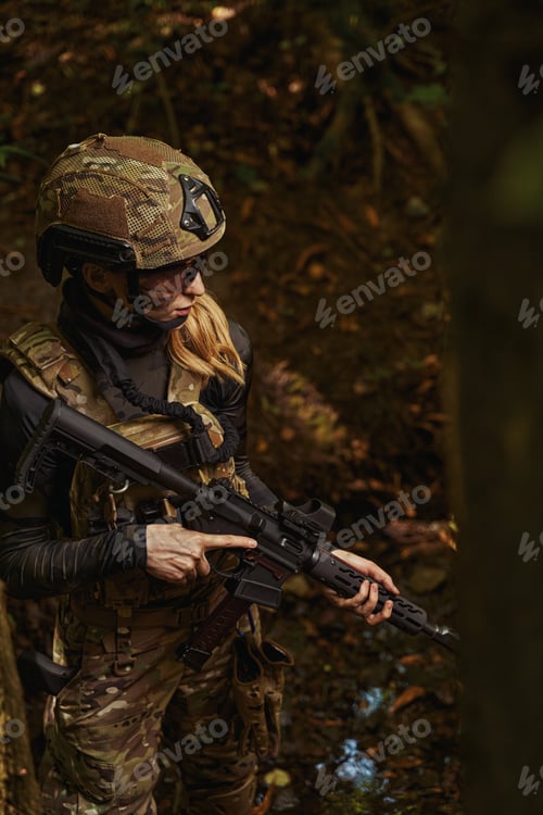 Preview: Woman standing in forest and holding hand firearms