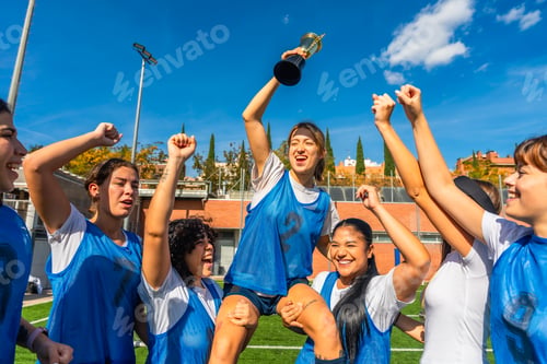 Preview: Women's soccer team celebrating championship with trophy