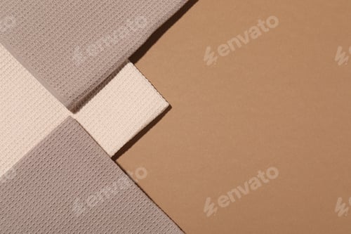Preview: Folded waffle towels on light brown background, flat lay. Space for text