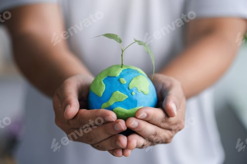 Preview: Man holding earth with green sapling. Love the earth. Love the earth concept. Environment concept.