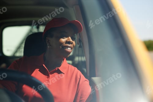 Preview: Driving Happy Female Worker in Delivery Truck