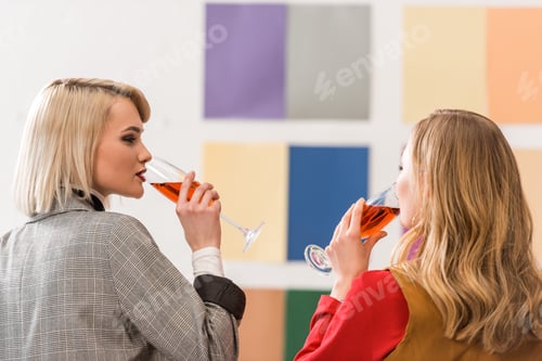 Preview: successful magazine editors celebrating and drinking champagne in modern office