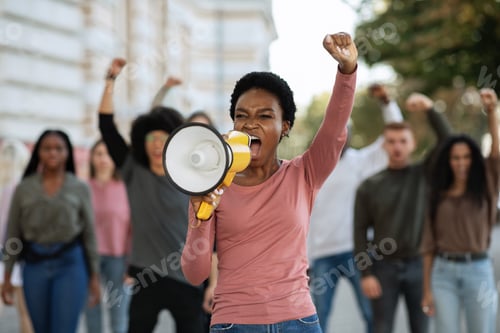 Preview: Black lady with megaphone leading group of demonstrators