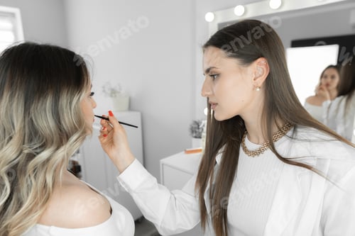 Preview: The photo conveys an exclusive moment when a young woman trusts her face to a makeup artist. The
