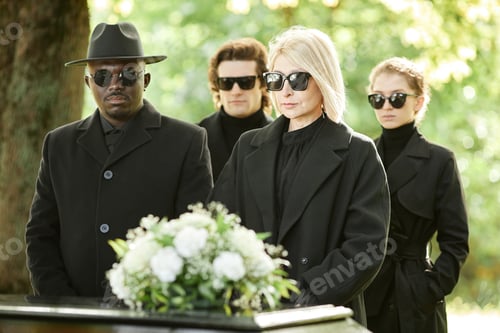 Preview: People wearing all black standing by coffin