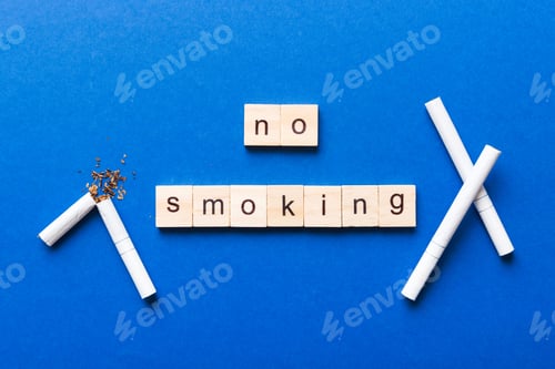Preview: Cigarette And Wooden Blocks, Broken cigarette on table background, No Tobacco Day