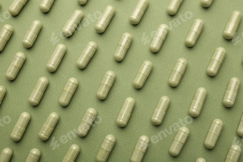 Preview: Vitamin capsules on olive background, flat lay