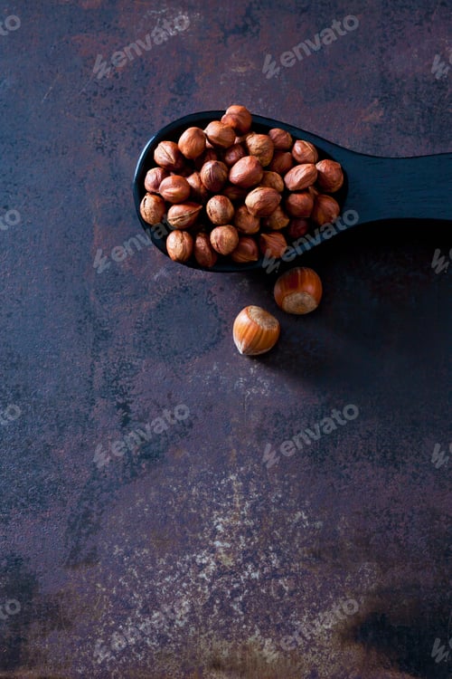 Preview: Spoon of cracked hazelnuts