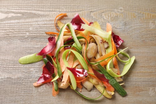 Preview: Peels of fresh vegetables on wooden table, top view