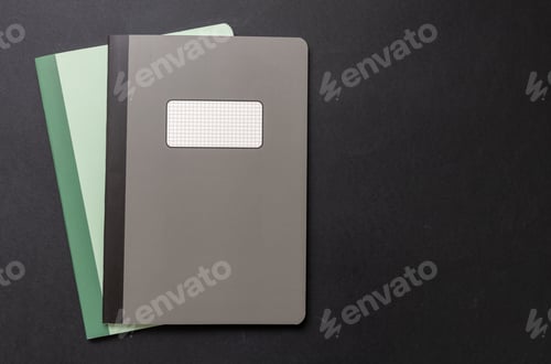 Preview: School notebooks stack, old fashioned, on black color background, blank label, copy space, top view.