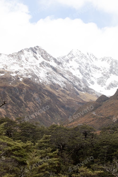 Preview: Majestic mountain landscape with snow-capped peaks and dense forest. Arthurs Pass, New Zealand