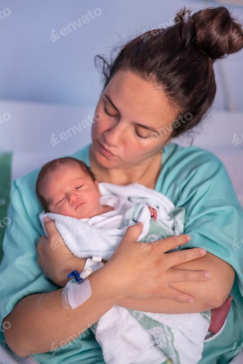 Preview: Mother tenderly holding her newborn baby in the hospital